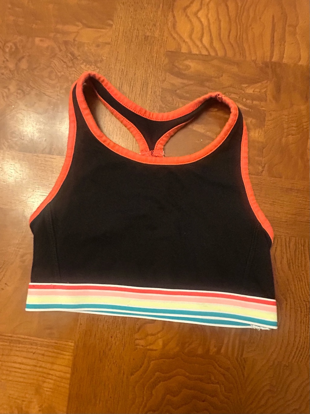 Girls Xersion Black Sports Bra with Neon Orange Trim and Rainbow Stripe Band